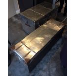 Two steel trunks as coffee tables in a brushed steel effect finish