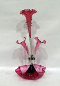 Pink glass epergne with three bowls as flowerheads, 55cm high