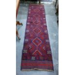 Meshwani wool runner with totem of lozenges in blue and red and having stylised crab border, 265 x