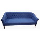 Deep button upholstered four-seat settee raised on turned supports