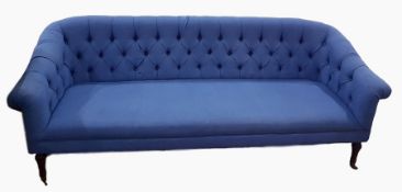 Deep button upholstered four-seat settee raised on turned supports