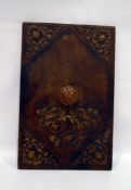 Embossed brown leather cover with brown leather handle embossed armorial and floral and shield