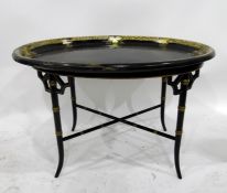 Oval moulded tray-top coffee table in the Oriental style, having floral and foliate decorative rim