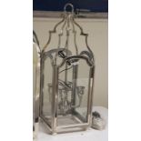 Four-branch hanging lantern within a glazed steel frame, height 85cm (VAT payable on hammer)