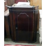 Late Georgian walnut hanging corner cupboard with fluted sides and applied panel door, 70cm wide