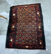 Small old Baluchi rug with graduated trellis work of allover stylised red and black plants on a