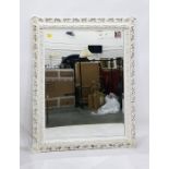 Large rectangular bevelled plate overmantel mirror within a white moulded and pierced acanthus