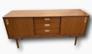 Contemporary teak sideboard with three short central drawers, flanked by cupboards with sliding