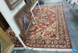 Large Persian style wool carpet, the brick red ground with large foliate medallion and spandrels,