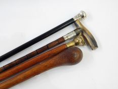 Collection of canes to include polished horn handle and silver bound bamboo cane with engraved