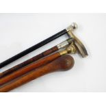 Collection of canes to include polished horn handle and silver bound bamboo cane with engraved