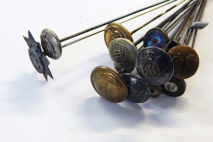 Quantity of hat pins with military button and badge terminals, including Devonshire badge