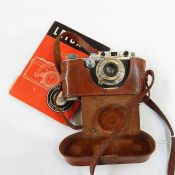 Leica III Model F, circa 1933, serial number 59542, in leather case and a Leica Guide book