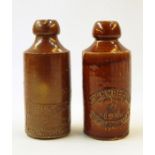 Two Schweppes stoneware ginger beer bottles with impressed marks (2)