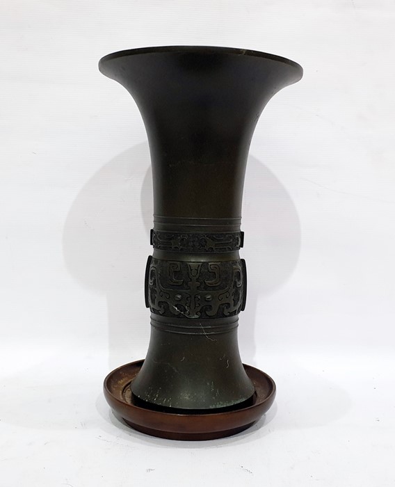 Early 20th century bronze vase, possibly Japanese, of flared rim form bearing inscription 'Presented