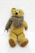 Large gold plush straw stuffed bear with glass eyes and stitched nose with a checkered scarf, height