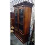 19th century mahogany bookcase with ogee moulded pediment above the two glazed doors, enclosing