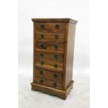 Eastern hardwood chest of seven short drawers each having metal drop ring handles and raised on