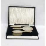 Four-piece silver-backed dressing table set comprising hand mirror, two brushes and a comb, with