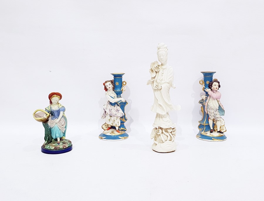 Chinese porcelain figure of Kuan Yin, on waterlily base, undecorated, 31cm high, pair tinted