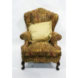 Wing-back armchair in yellow patterned upholstery to cabriole front legs