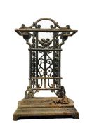 Cast iron umbrella stand with scrolling decorative back panel, removable drip tray