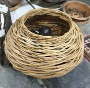 Quantity of fisherman's glass floats in wicker basket