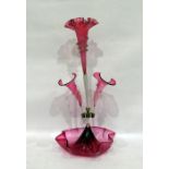 Pink glass epergne with three bowls as flowerheads, 55cm high  Central arm is tilting slightly to