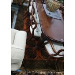 Burnt orange ground Eastern style floor rug, the central field decorated with elephant foot guls,