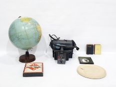 Globe, Polaroid camera, book of Common Prayer, travel Monopoly set, profile plaque of a young child,