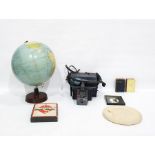 Globe, Polaroid camera, book of Common Prayer, travel Monopoly set, profile plaque of a young child,