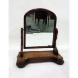 Victorian mahogany toilet mirror, the arched plate on scroll supports, shaped plinth base