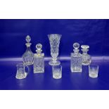 Cut glass vase of flared form, on knopped stem, four cut glass decanters, a cut glass jug and a pair