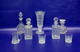 Cut glass vase of flared form, on knopped stem, four cut glass decanters, a cut glass jug and a pair