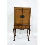 20th century walnut cocktail cabinet with two cupboard doors enclosing mirrored interior, above