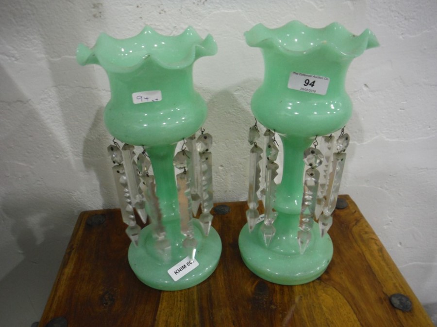 Pair of Victorian lustre vases, the green glass vases hung with cut glass lustres and a pair of