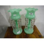 Pair of Victorian lustre vases, the green glass vases hung with cut glass lustres and a pair of