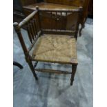 Brass and wire spark guard and a rush-seated corner chair (2)
