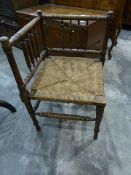 Brass and wire spark guard and a rush-seated corner chair (2)