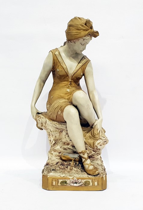 Royal Dux porcelain figure of a girl in bathing suit, seated on a rock and drying her feet, all on