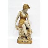 Royal Dux porcelain figure of a girl in bathing suit, seated on a rock and drying her feet, all on