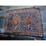 Eastern wool rug with double lozenge totem, having stylised animals on a midnight blue ground with