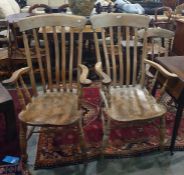 Two beech and elm seated slat-back carver chairs with turned front legs and stretchered bases (2)