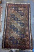 Eastern style brown ground rug with repeating hooked motif pattern 150 x 85 cm