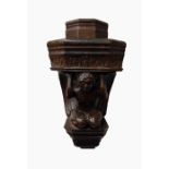 Carved oak wall-hanging corbel of an angel supporting foliate decorated platform, 31cm high and a