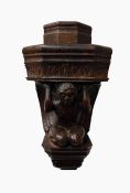 Carved oak wall-hanging corbel of an angel supporting foliate decorated platform, 31cm high and a