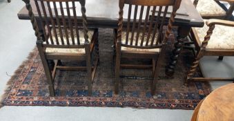 Eastern rug, the central field with repeating hook medallions, on a stepped border featuring flowers