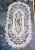 20th century cream ground rug with foliate spray to centre, 150cm x 82cm