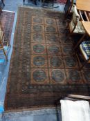 Large brown ground Eastern floor rug with four rows of six elephant foot gul medallions to the