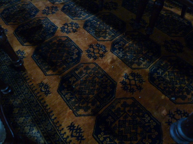 Burnt orange ground Eastern style floor rug, the central field decorated with elephant foot guls, - Image 2 of 5